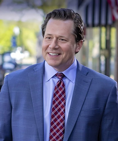 Small group of campaign managers smiling together in a modern office
